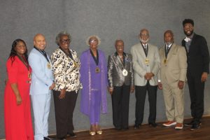 Pictured are, from left, Michelle Porter, Carl O. Sherman, Colissa Hunter (accepting for Melvin H. Hunter, Jr.), Florence Henderson (accepting for Don C. Edwards, Jr.), Shirley Watson, Jesse Gibson, Eric Smith and Jibril Rasheed. (Chris Roark/staff photo)
