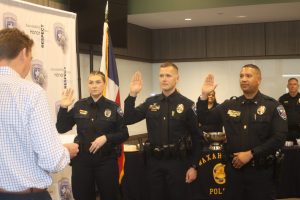City Manager MIchael Scott administers the oath of honor to Cpl. Jill Turner, Sgt. Dustin Koch and Lt. Derrick Young. (Chris Roark/staff photo)