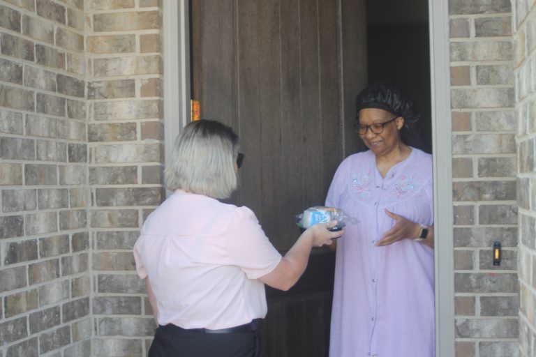Haley Seale, marketing and communications manager for Meals on Wheels North Central Texas, delivers food to a local resident. (Chris Roark/staff photo)