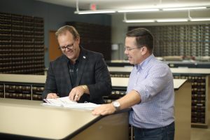Ellis County Judge Todd Little and Chief of Staff Ryan Garrett check the fiscal year 2024 budget one last time before filing it with the county Clerk. (Courtesy of Ellis County)